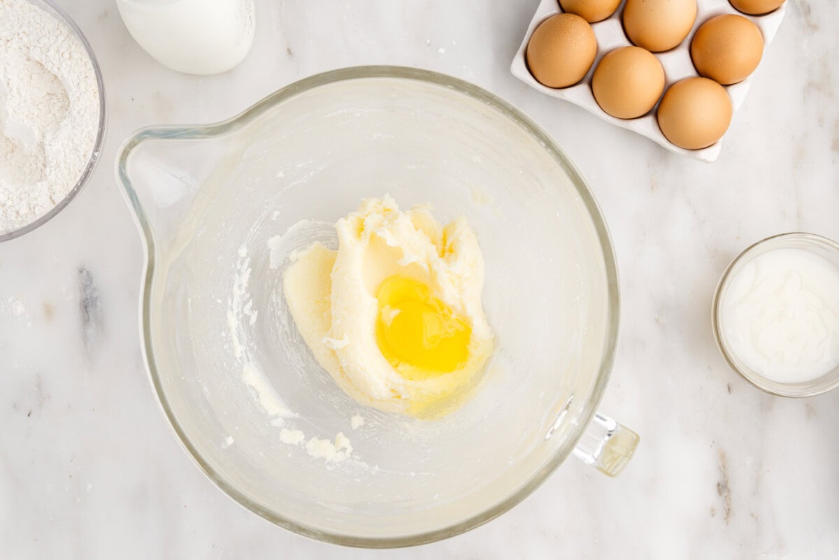 adding egg to butter and sugar mixture