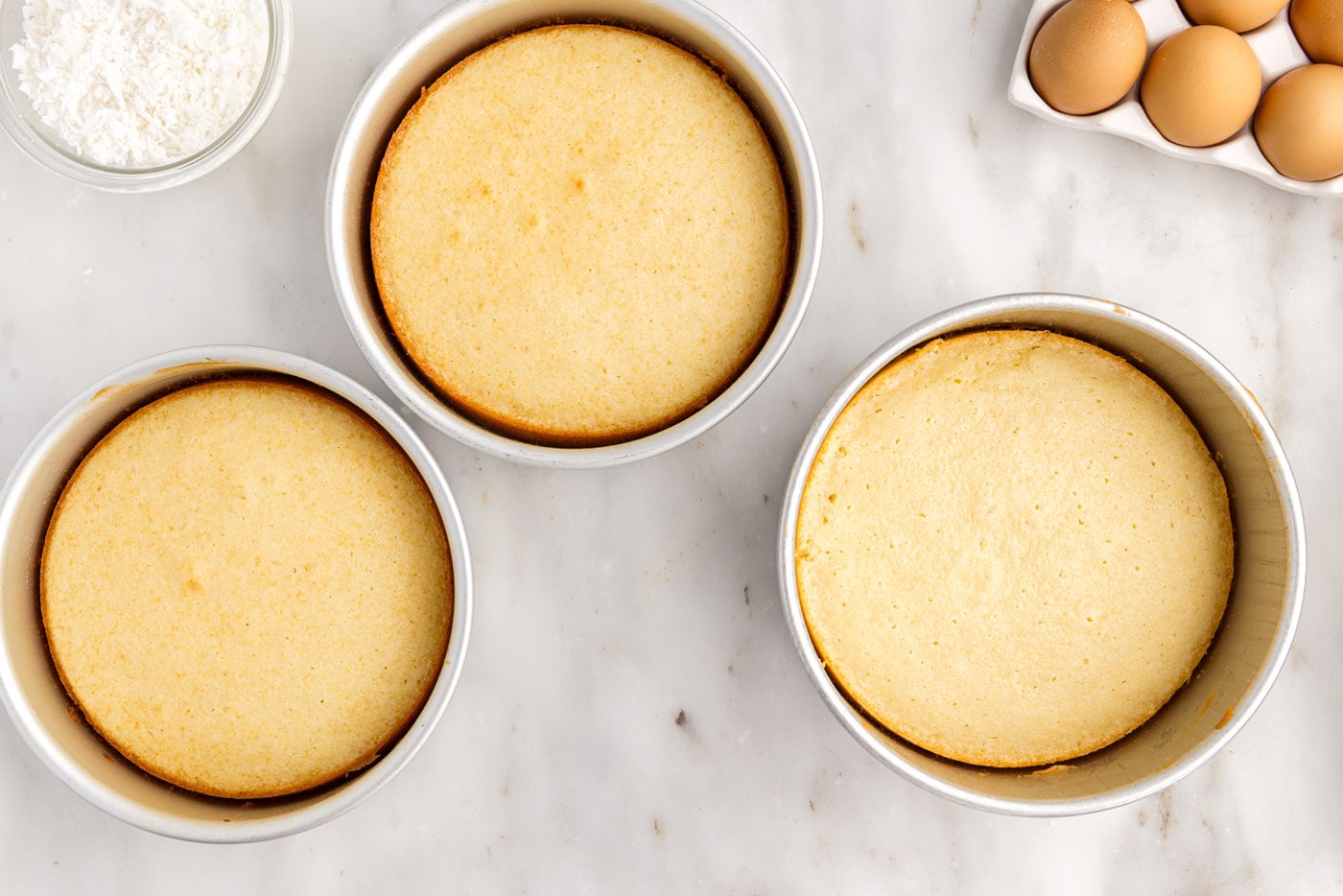 baked coconut cakes in round pans