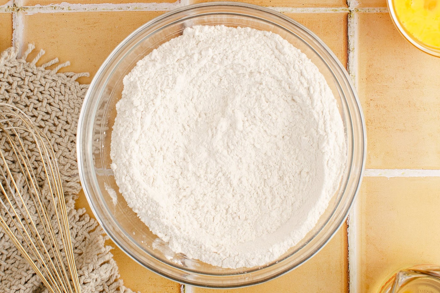 flour, baking powder, baking soda, and salt mixed in a bowl
