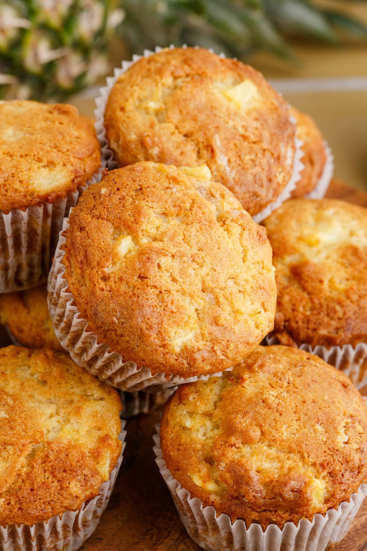Pineapple Muffins stacked on a wooden plate