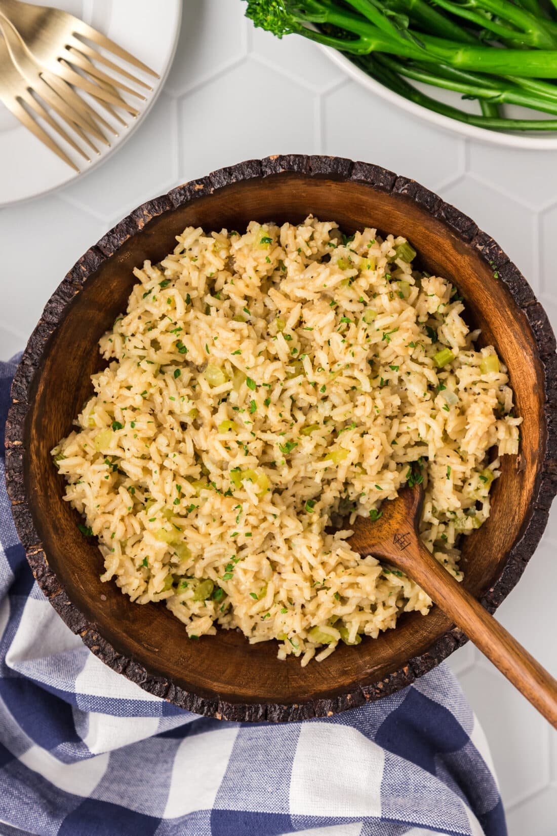 Rice Pilaf in a wooden bowl with a wooden spoon