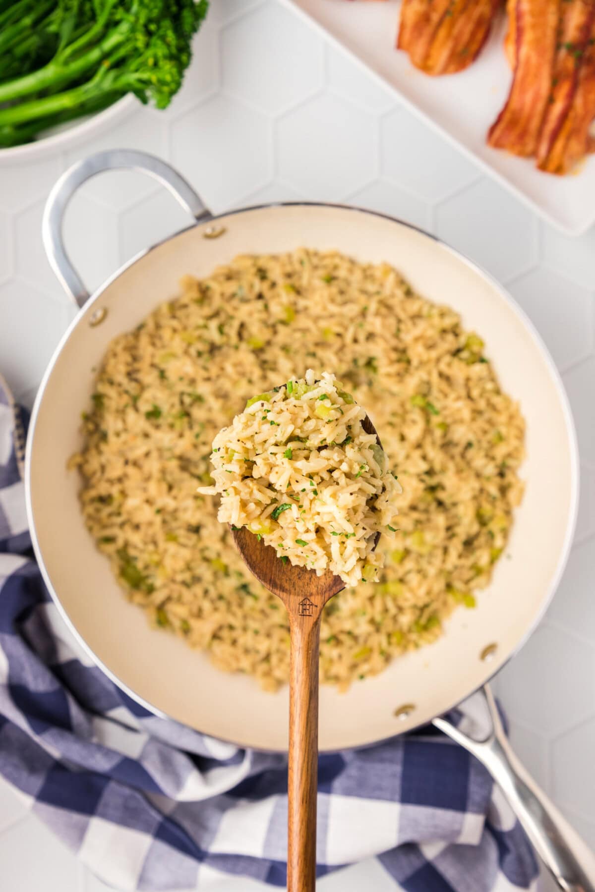 Spoonful of Rice Pilaf held above a skillet of Rice Pilaf
