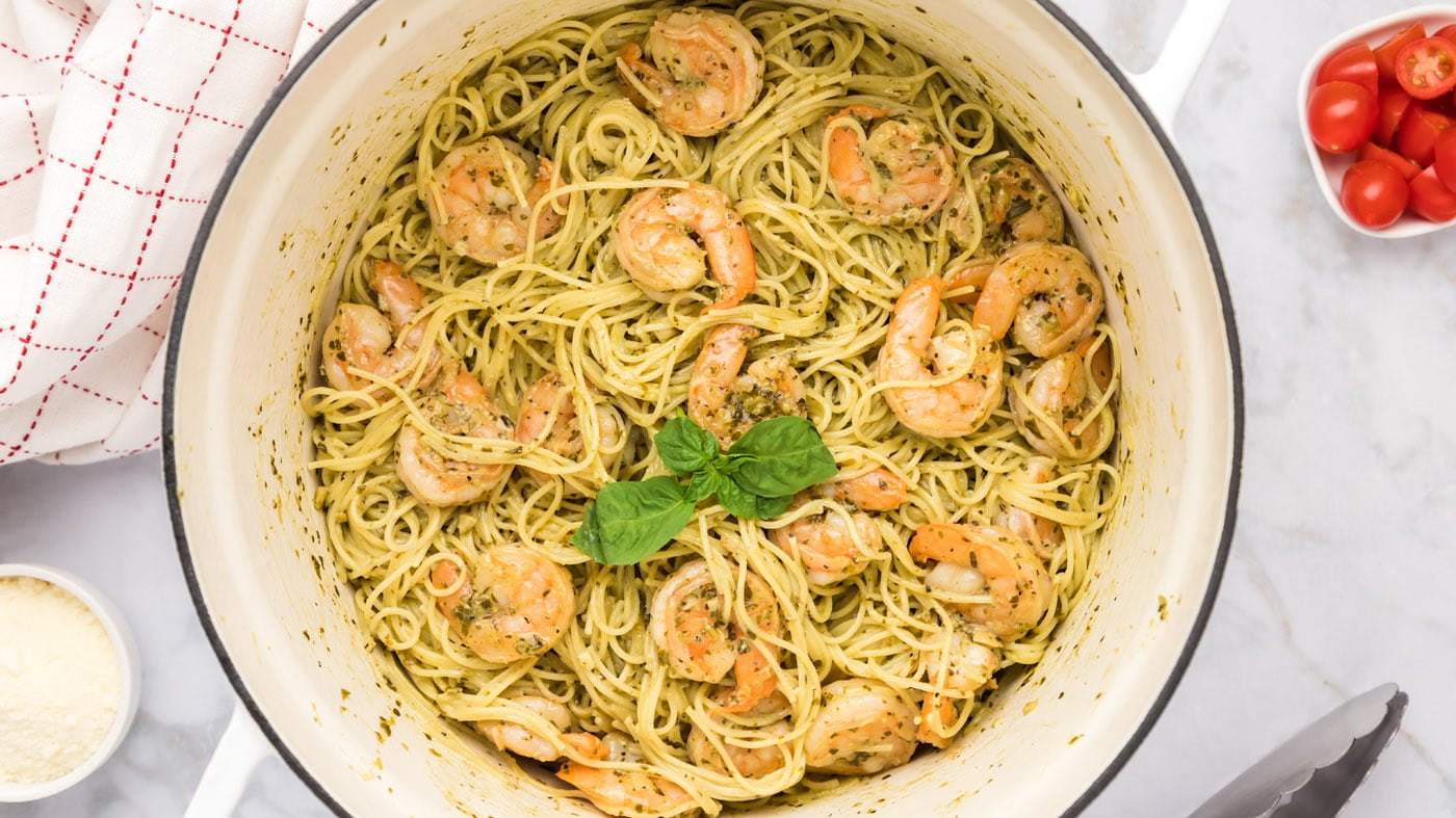 Shrimp pesto pasta comes together quickly. Simply cook your pasta, sautee that shrimp, then toss the