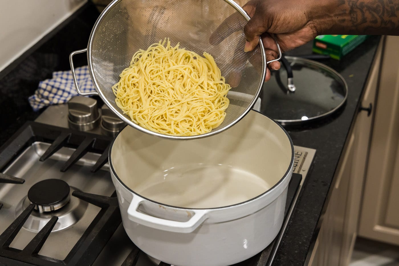 draining pasta in a sieve