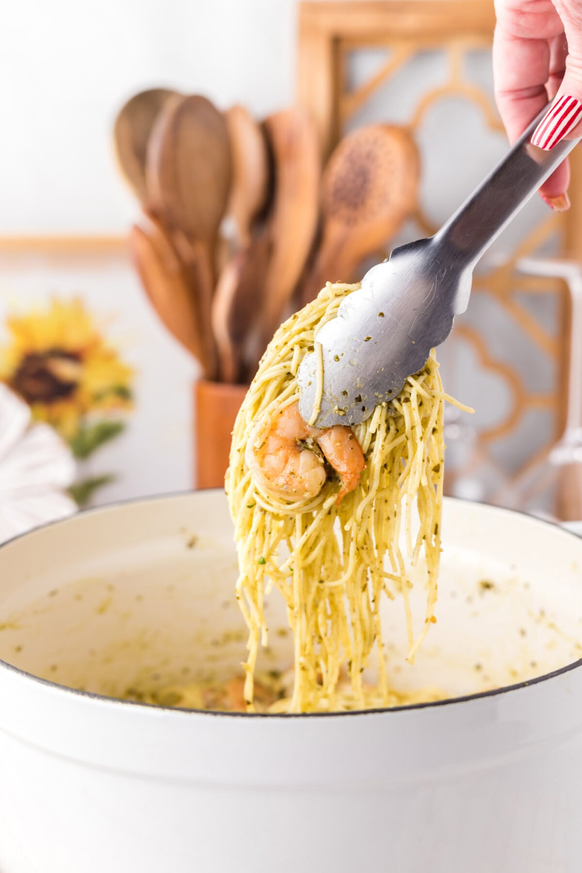 Tongs picking up Shrimp Pesto Pasta