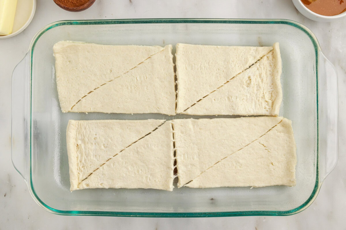 crescent roll dough on the bottom of a baking dish