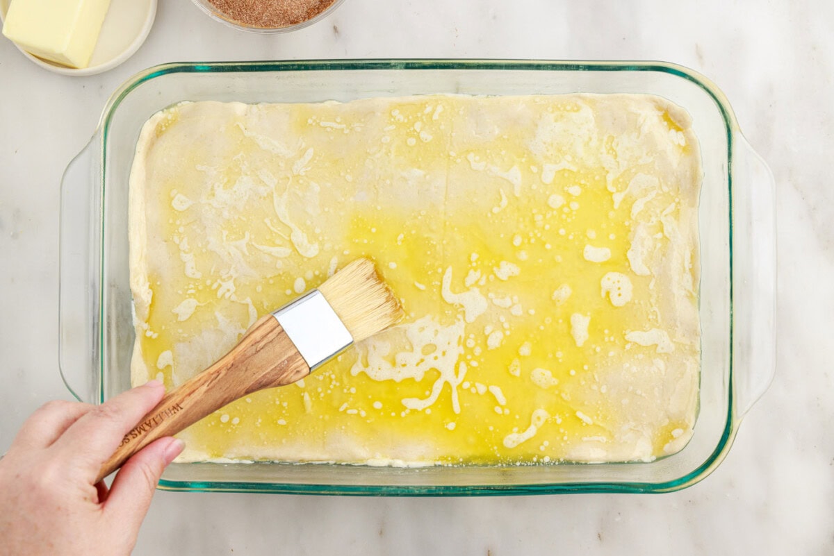 spreading butter over crescent dough sheet