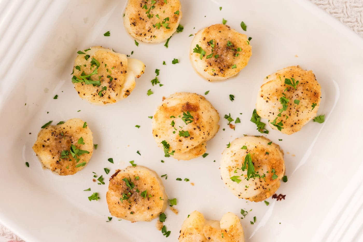 These tender, buttery baked scallops come together quickly in the oven with a lightly crisp topping 