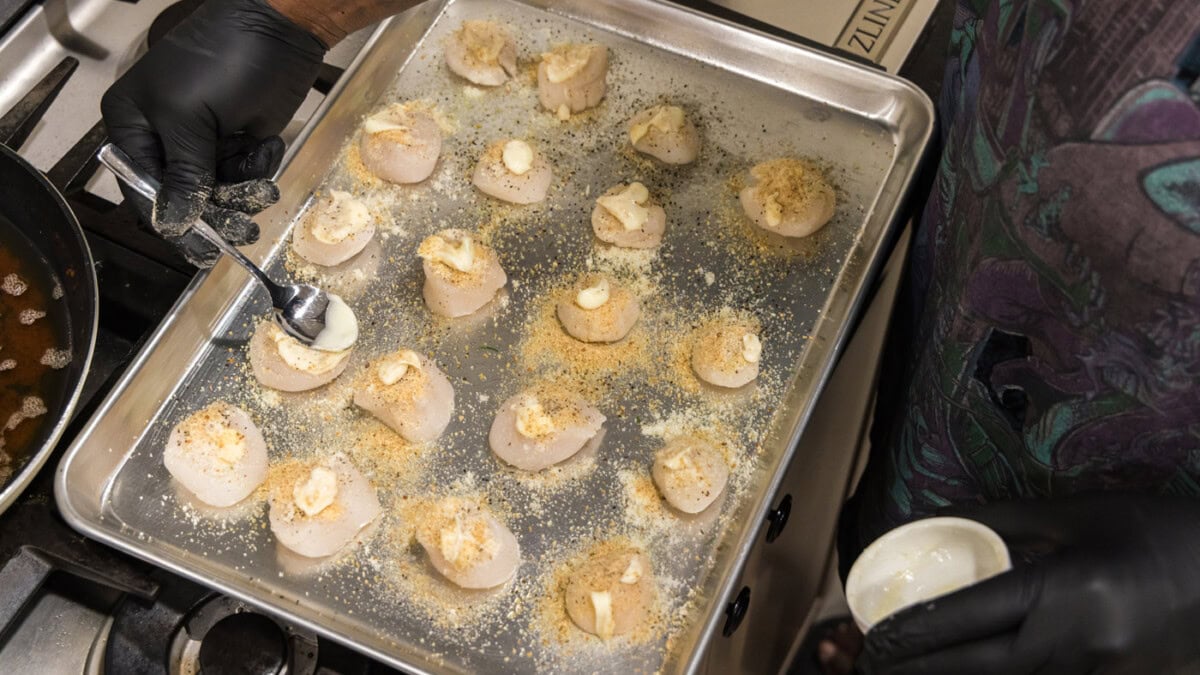 brushing butter on scallops
