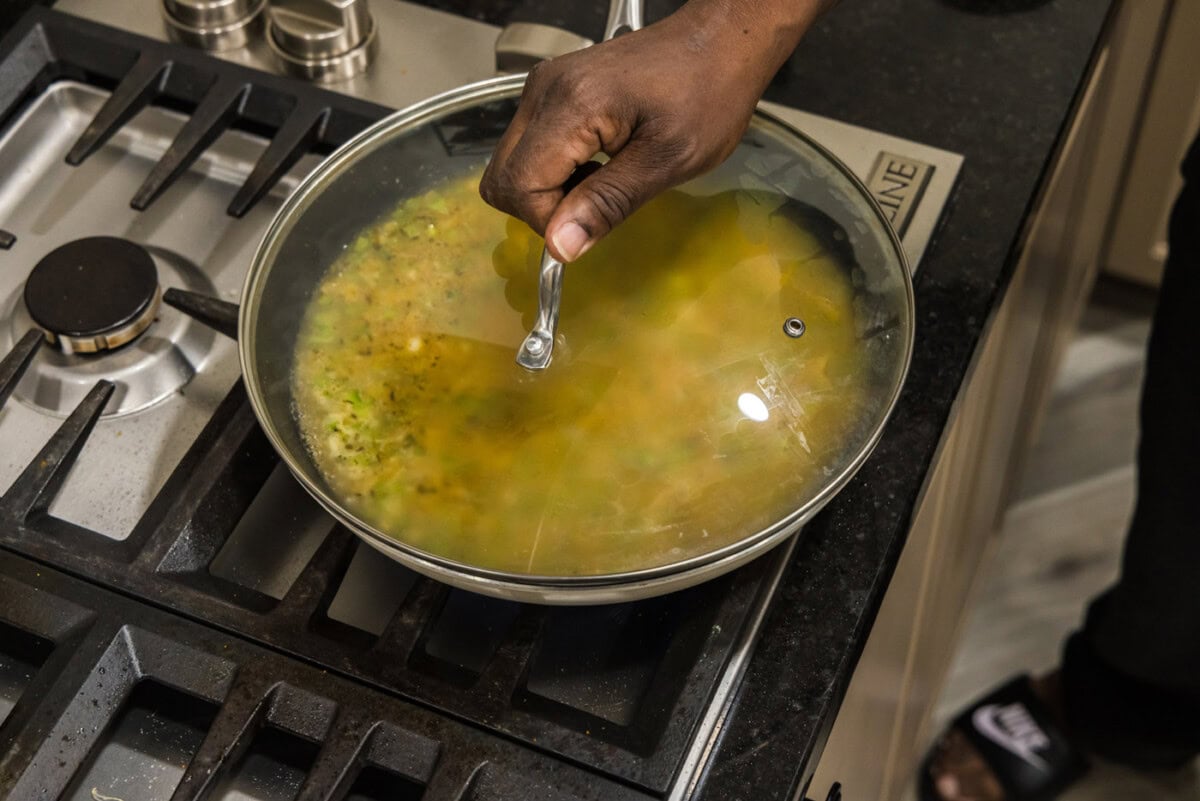 putting lid on skillet while making cajun rice