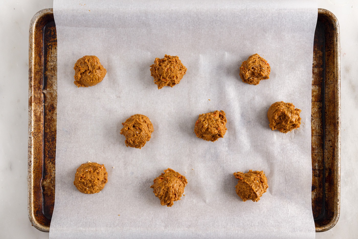 carrot cake cookie dough balls on parchment paper