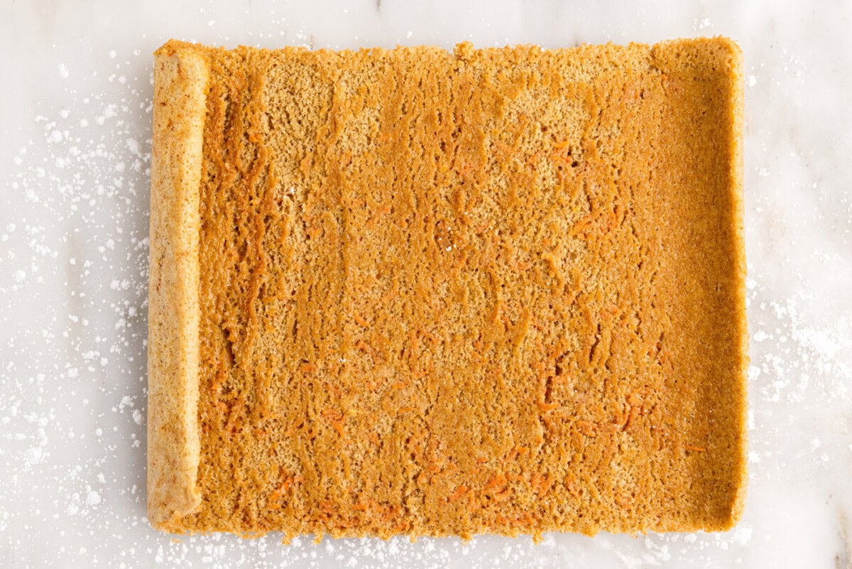 carrot cake roll unrolled on surface