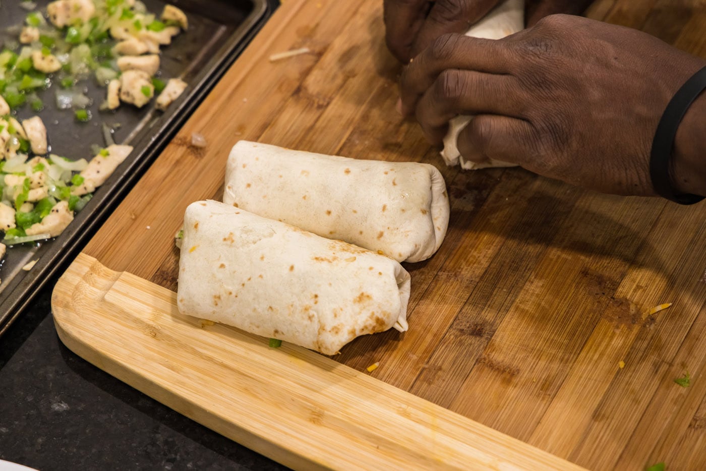 chimichangas rolled on a cutting board