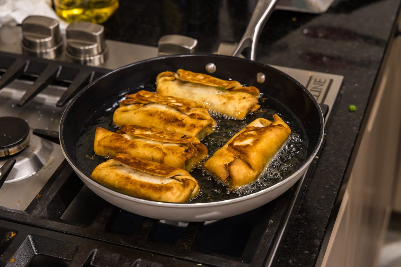 deep fried chimichangas on the stovetop