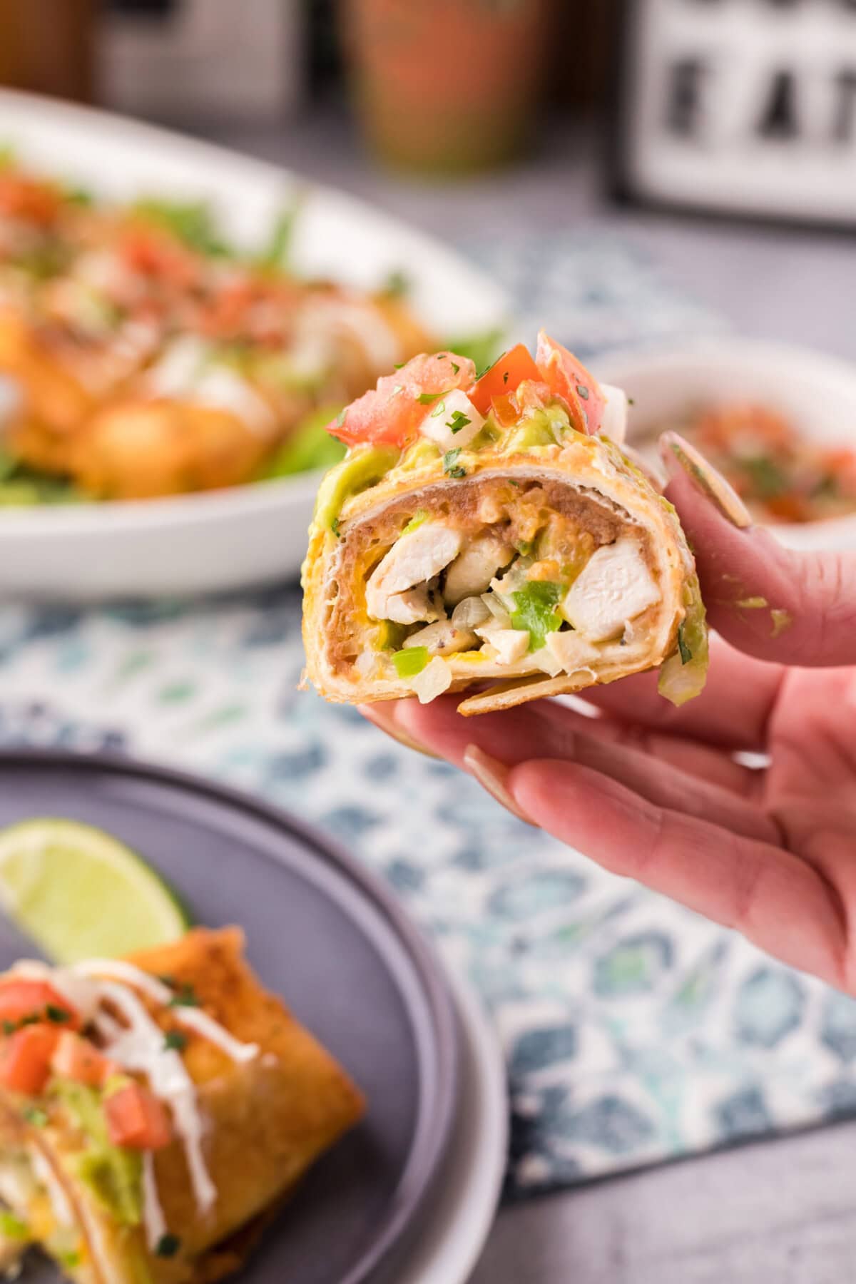 Hand holding half of a Chimichanga