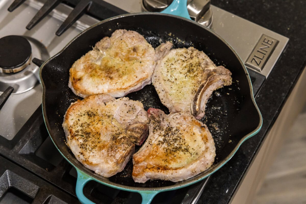 seared pork chops in a skillet