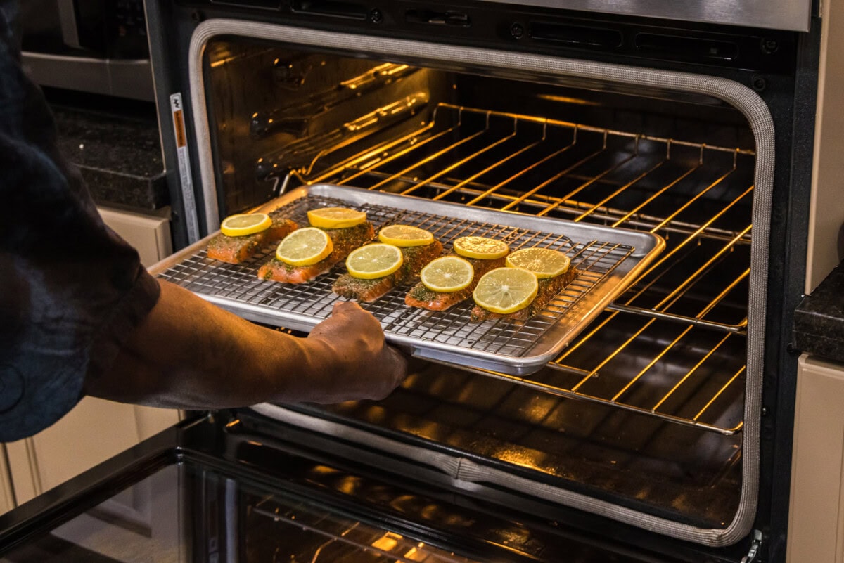 placing dill salmon into the oven