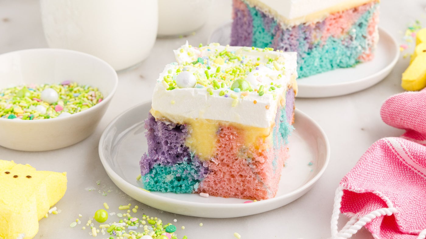 This Easter poke cake is cheery and bright with pastel purple, pink, and blue cake swirled together 