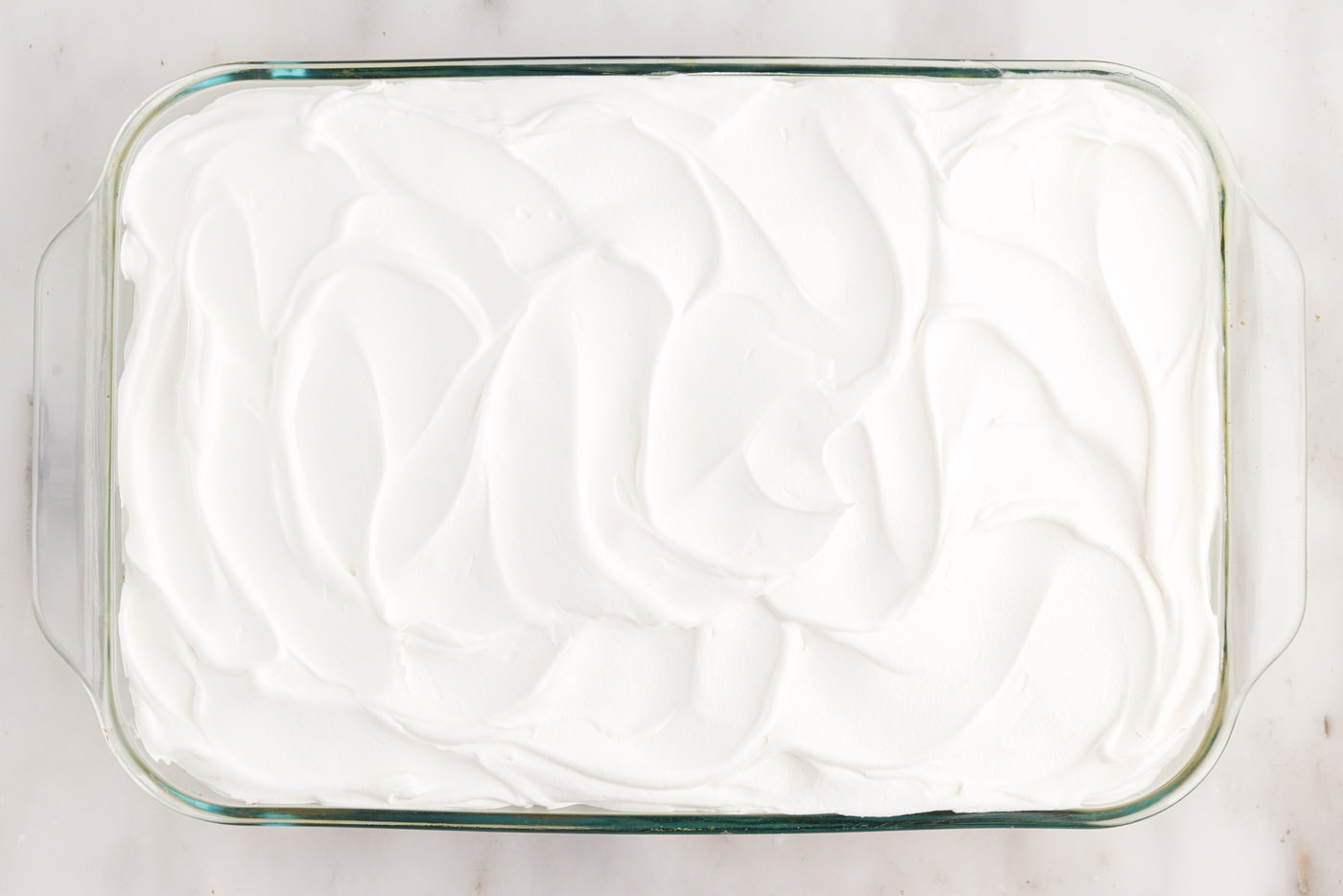 swirled cool whip on top of cake