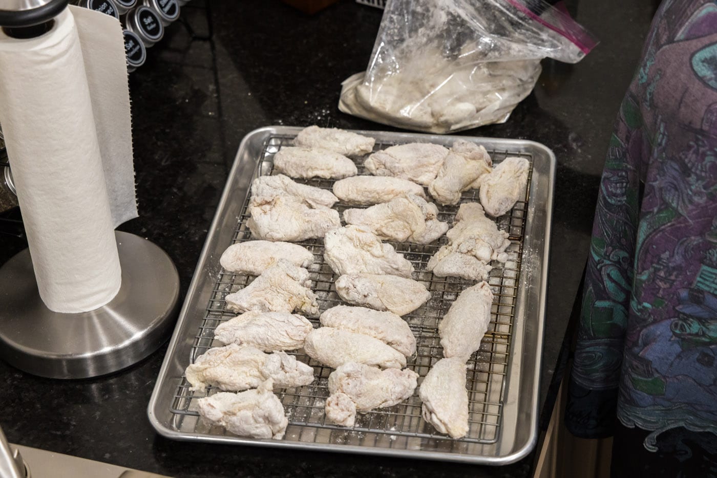 floured chicken wings on a baking sheet