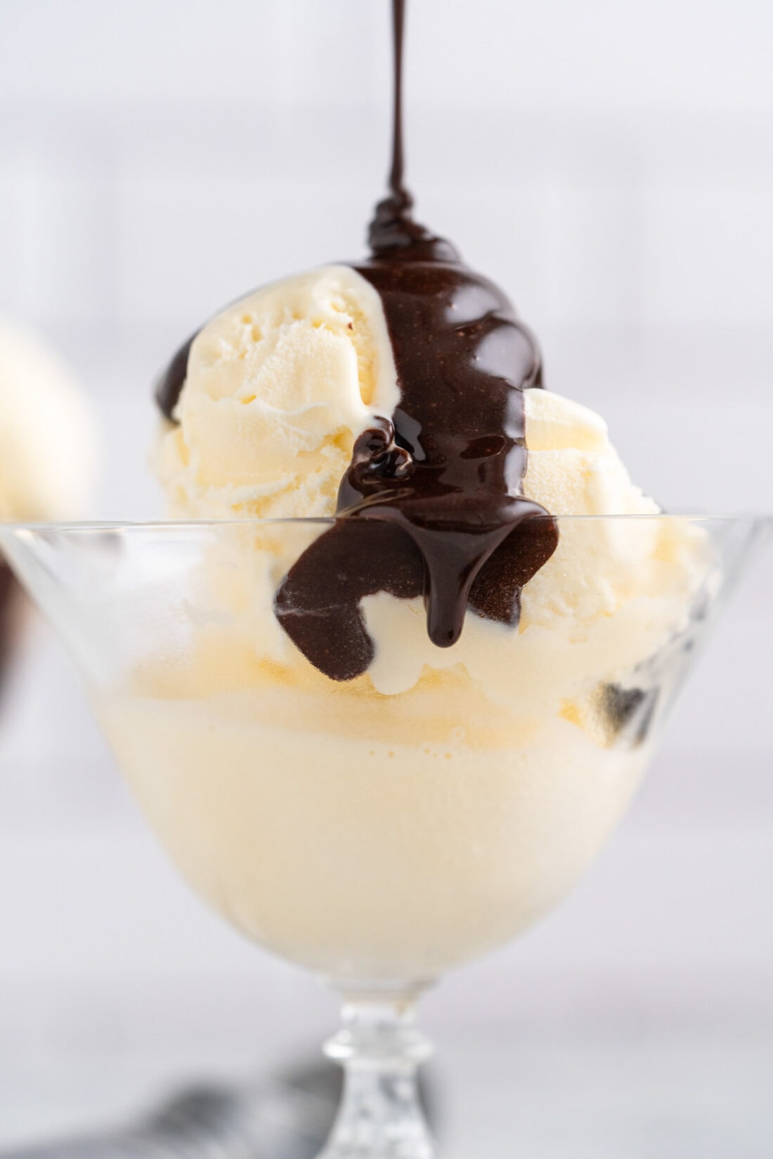Hot Fudge being drizzled over ice cream