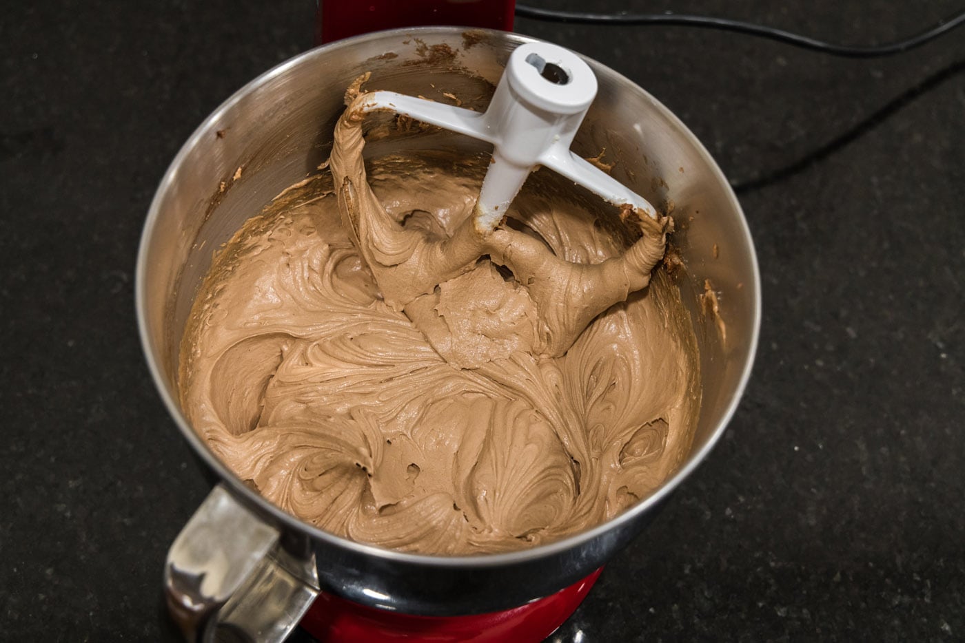 finished french silk pie filling in a mixing bowl with beater