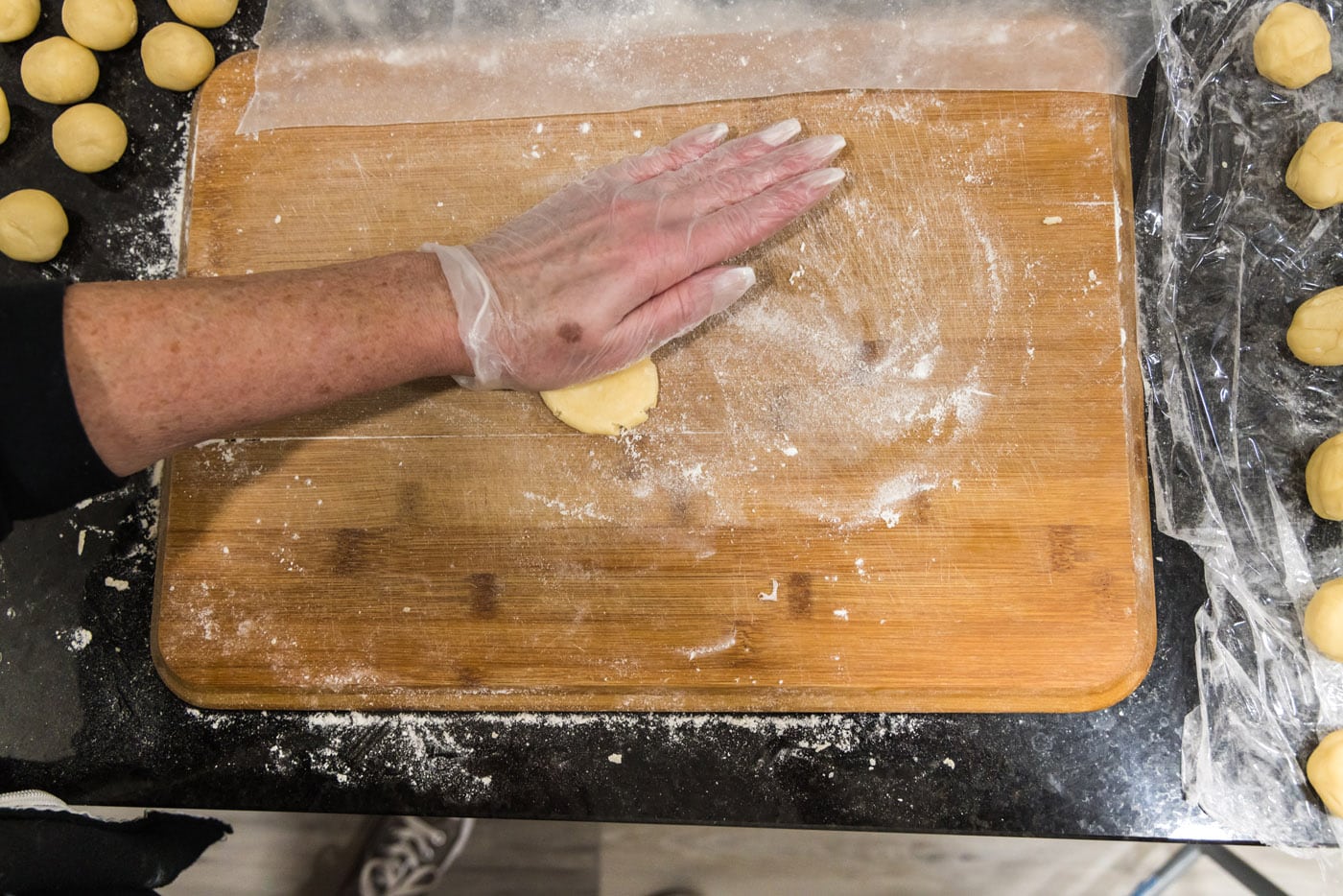hand flattening pie dough