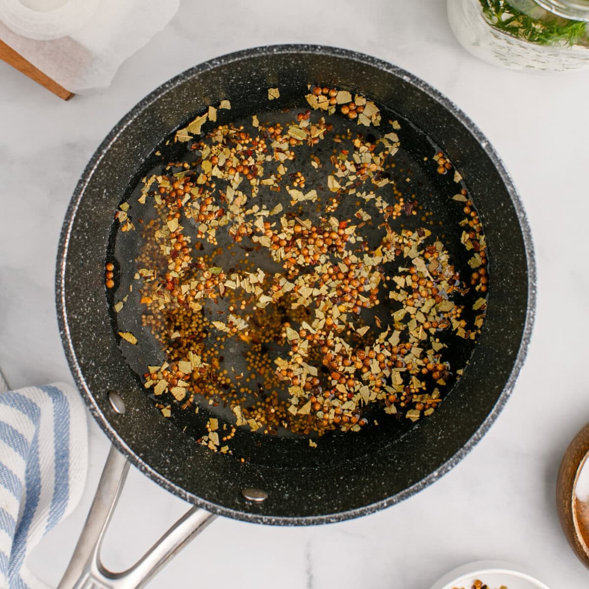 pickling spices added to vinegar in a saucepan