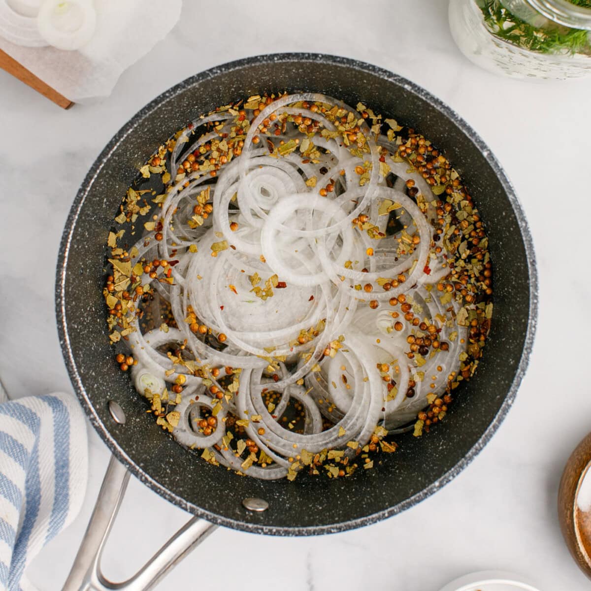 sliced onion added to saucepan with pickled eggs brine