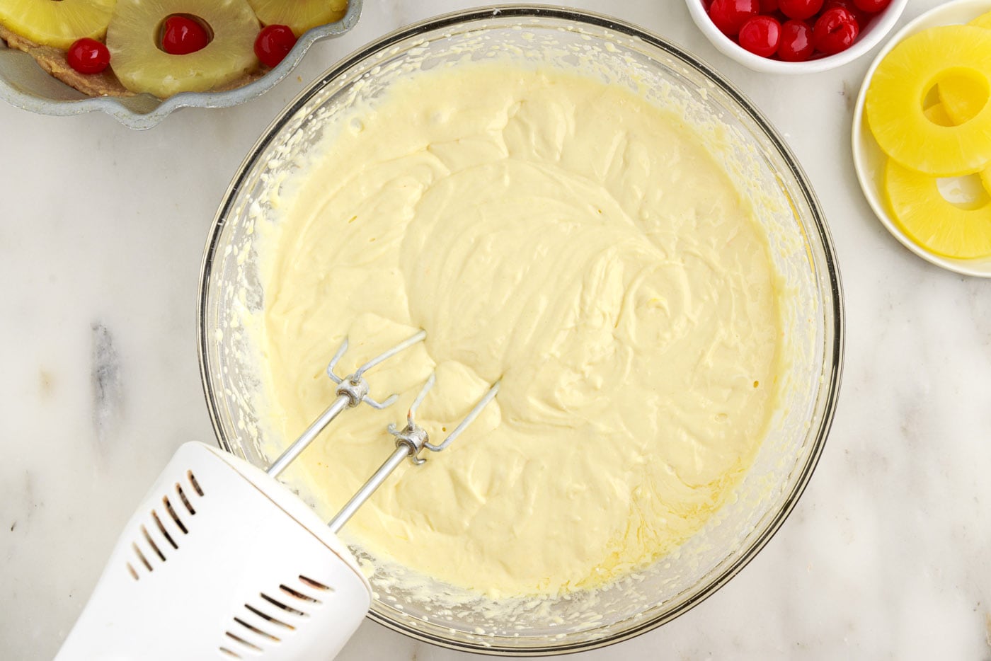 bundt cake batter in a bowl with a mixer