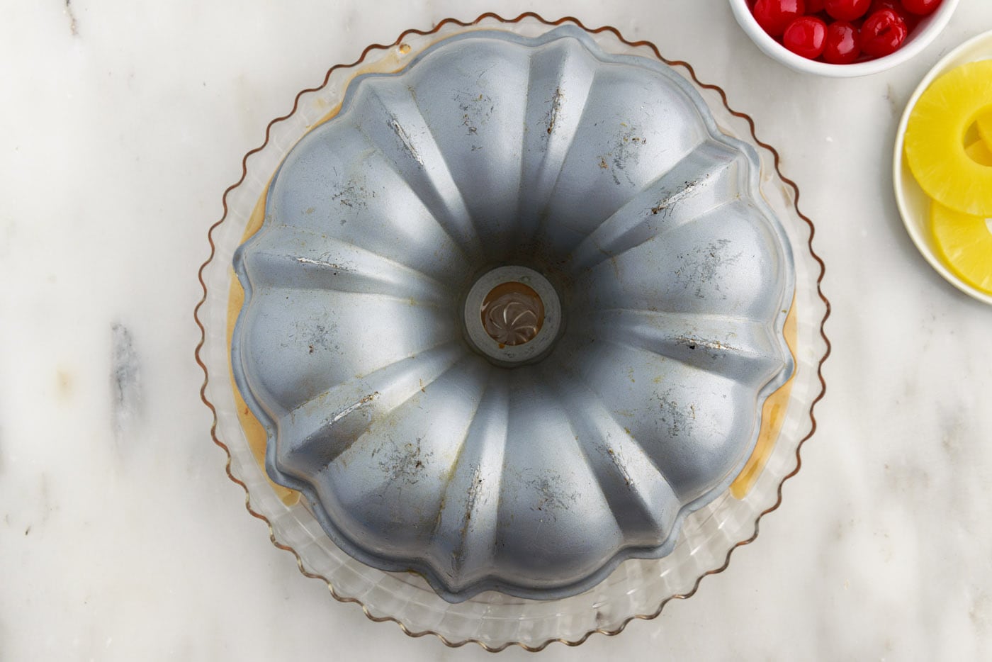 turning bundt cake pan inverted on a plate