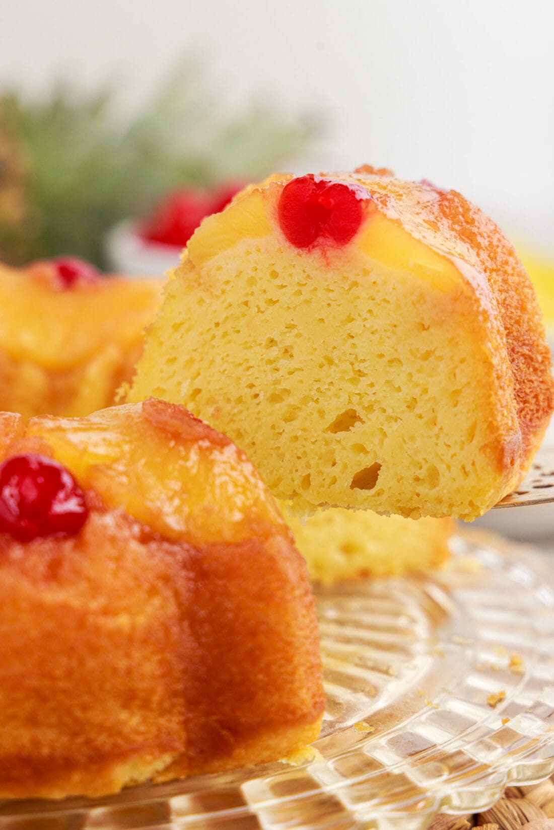 Close up photo of a slice being removed from a Pineapple Upside Down Bundt Cake