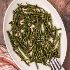 Roasted Green Beans on a serving platter with a serving fork