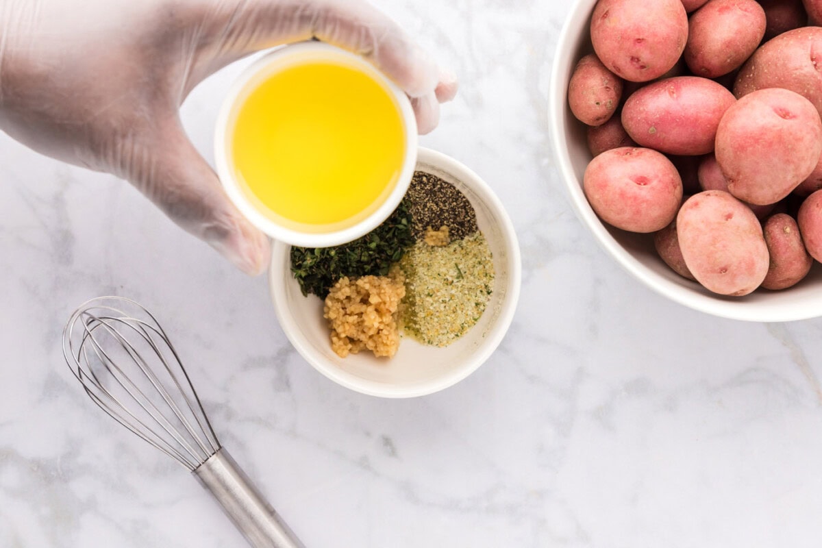 olive oil over a bowl of seasonings