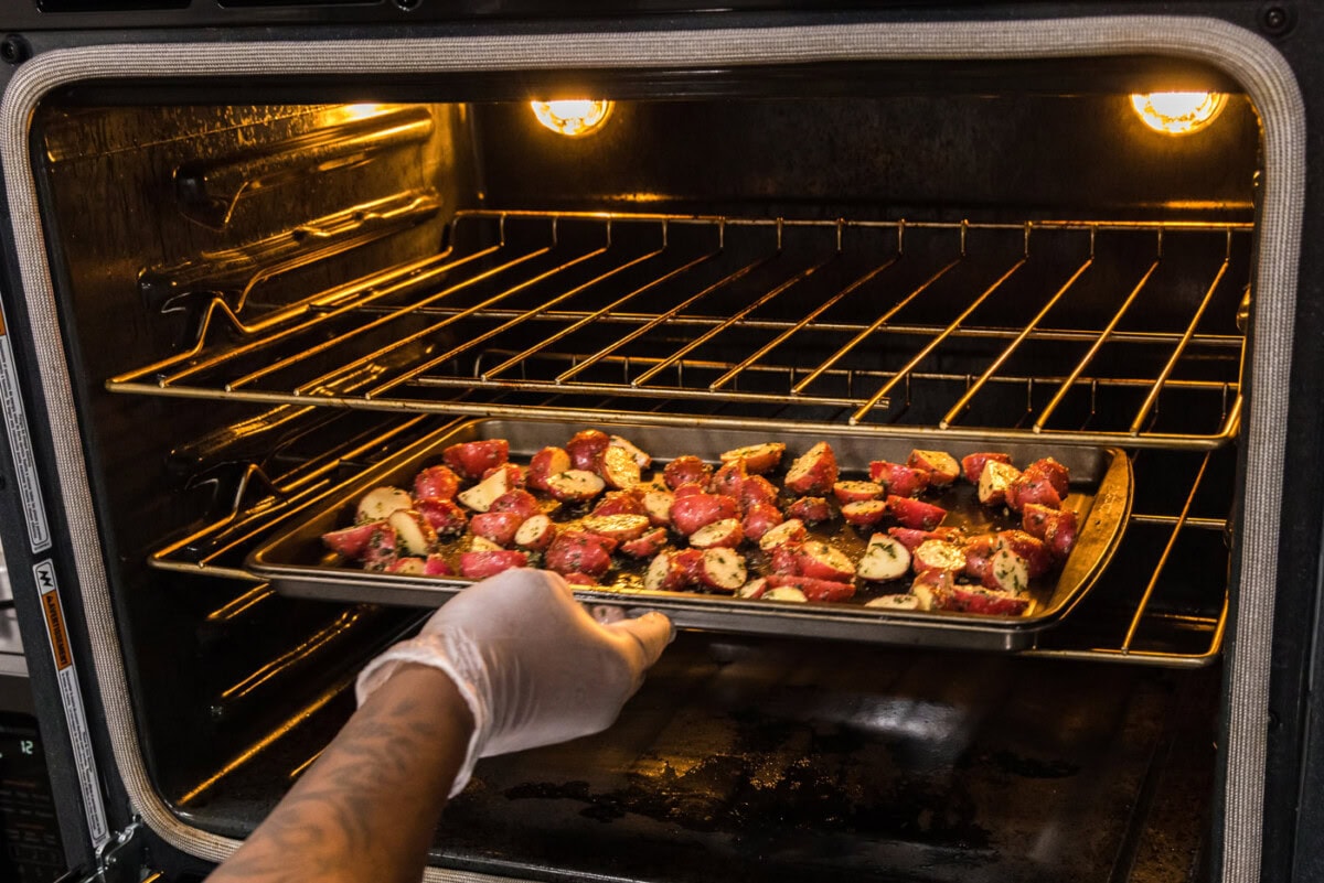 red potatoes on a baking sheet in the oven