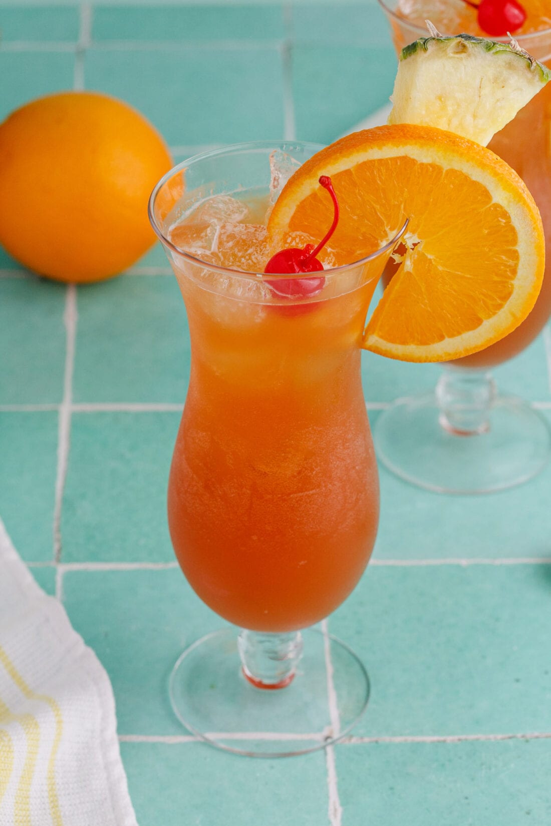 Rum Runner garnished with an orange wheel, pineapple wedge and cherry