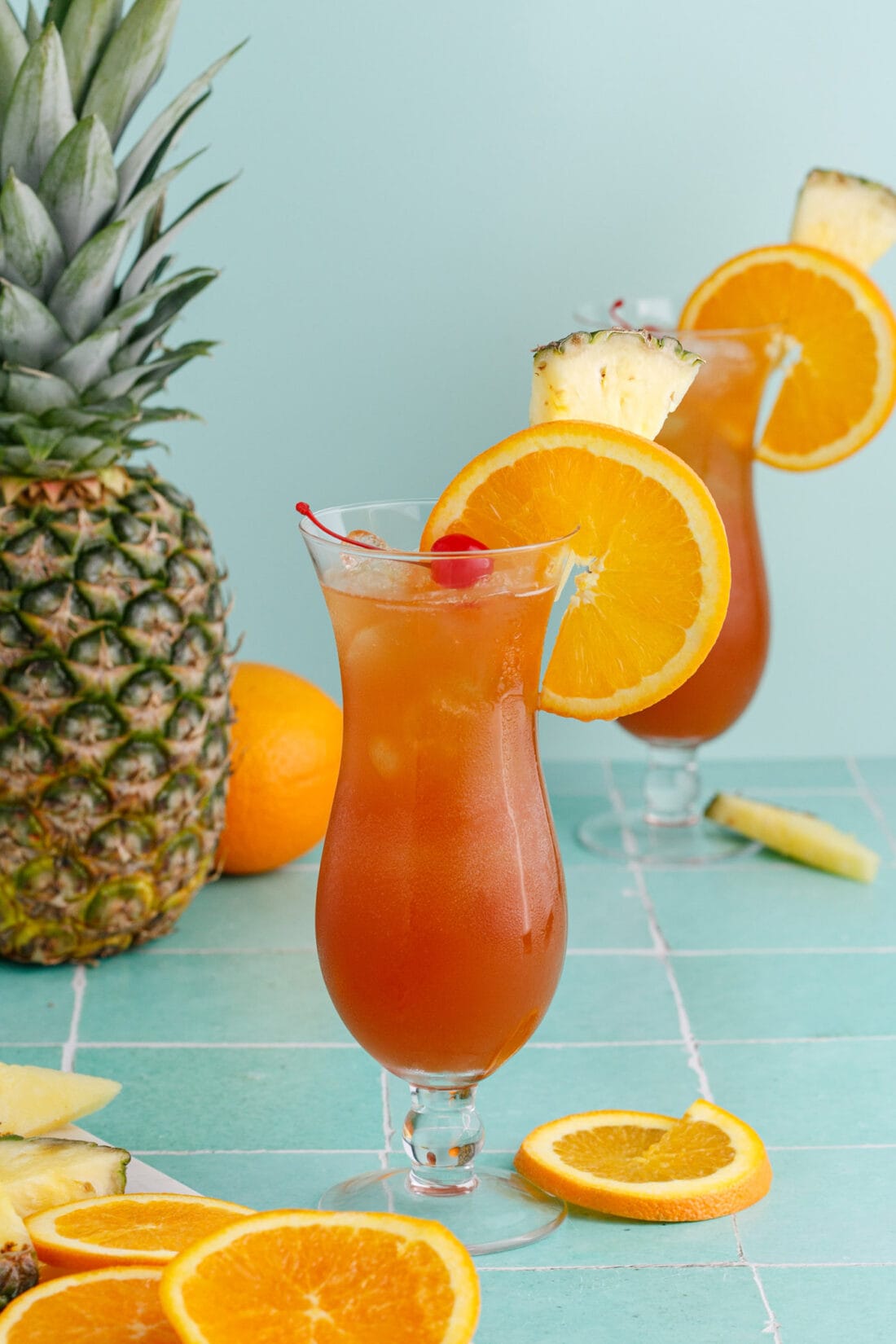 Rum Runner with garnishes and a pineapple in the background