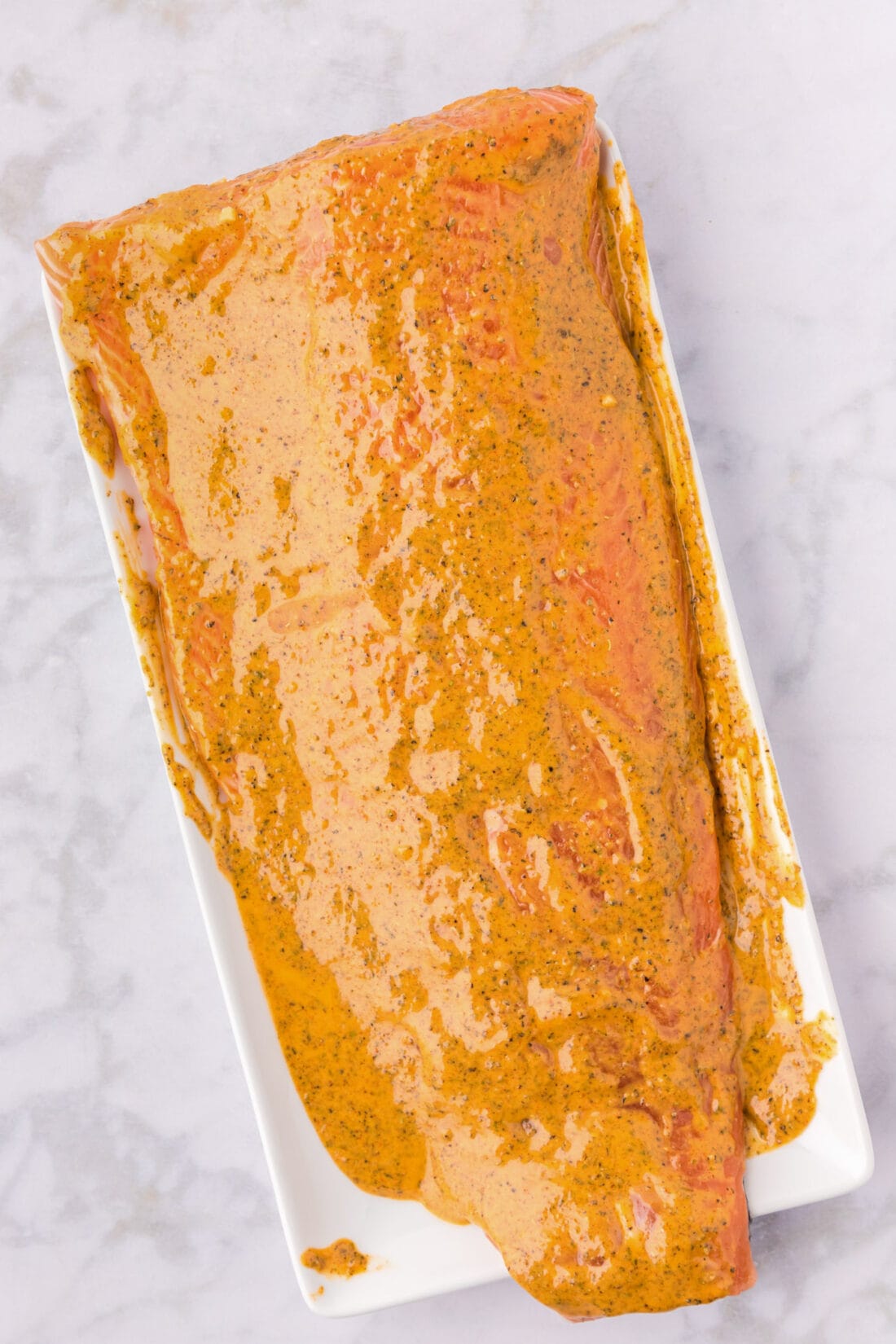 Salmon Marinade spread on salmon on a serving tray