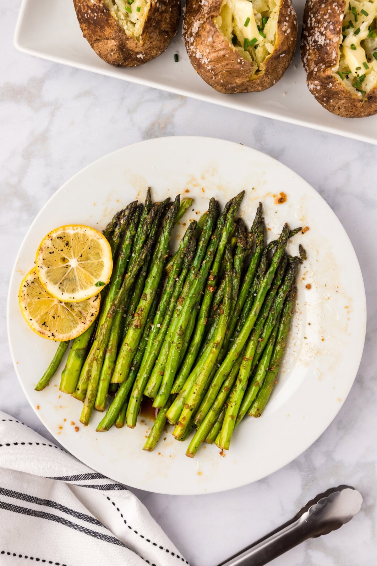 Sautéed Asparagus on a plate with lemon slices