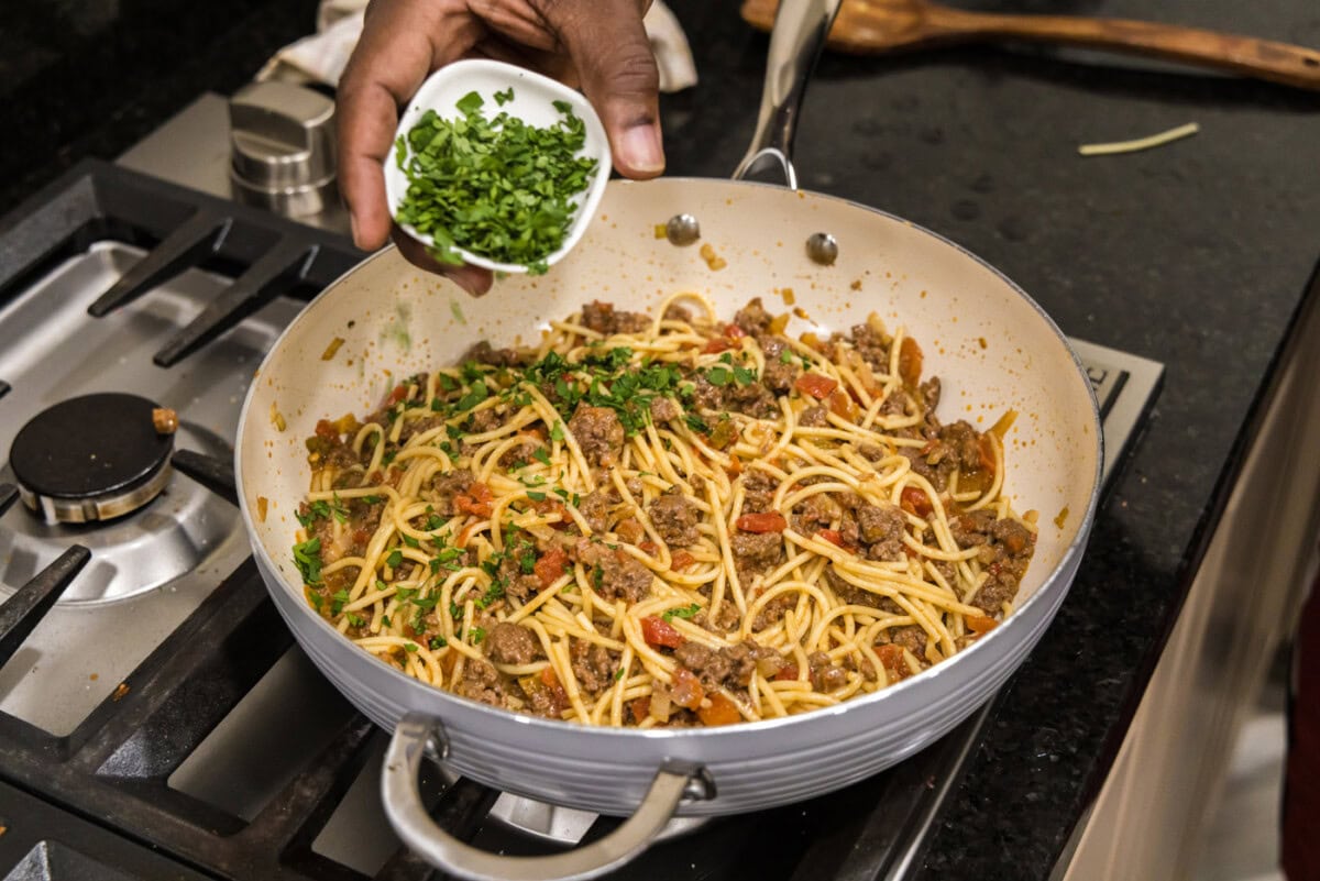 adding cilantro to taco spaghetti