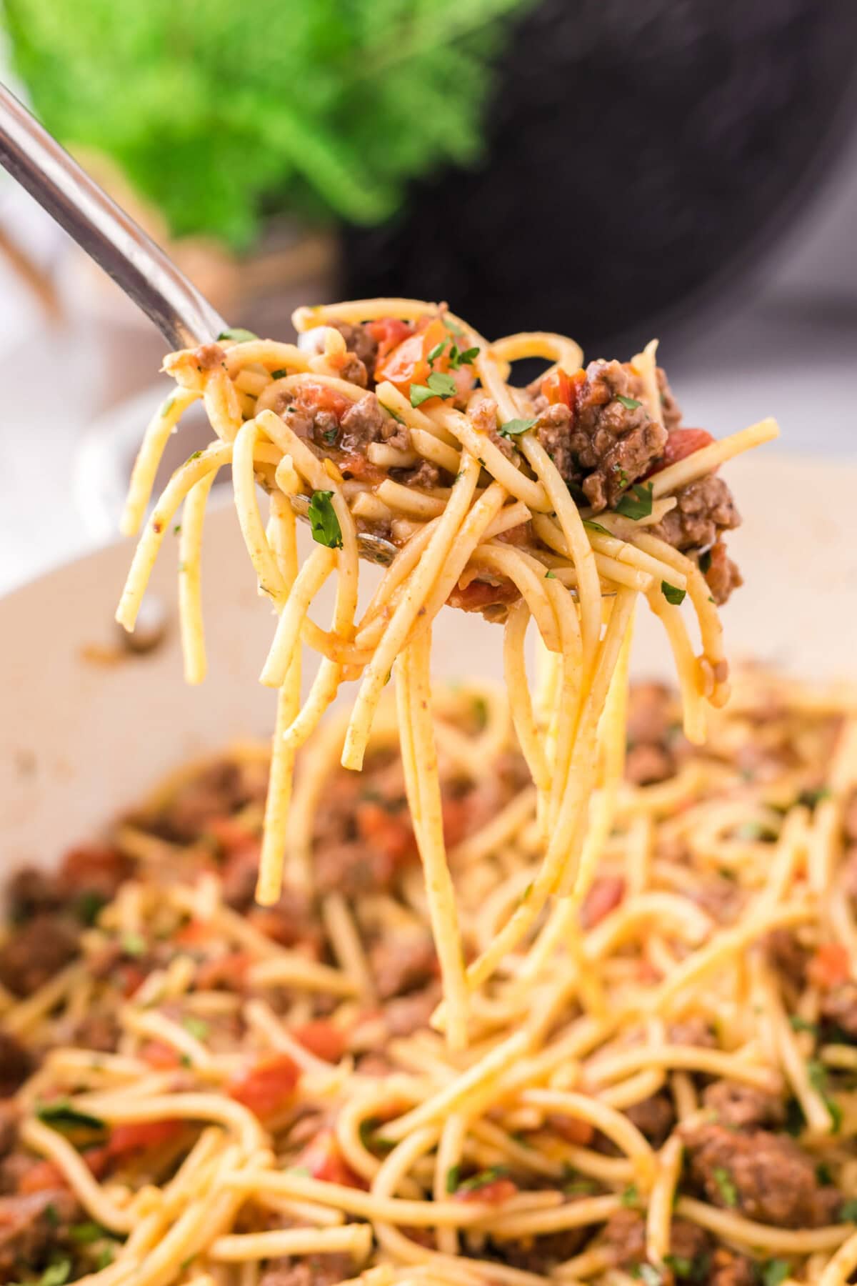 Spoonful of Taco Spaghetti being lifted out of the skillet of Taco Spaghetti