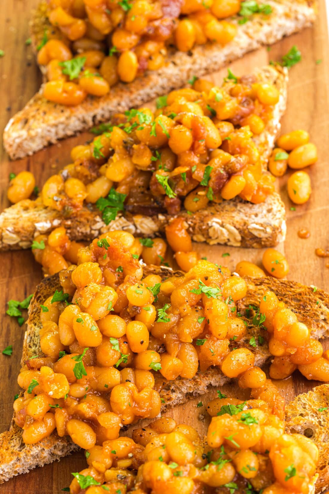 Close up photo of Beans on Toast on a wooden platter