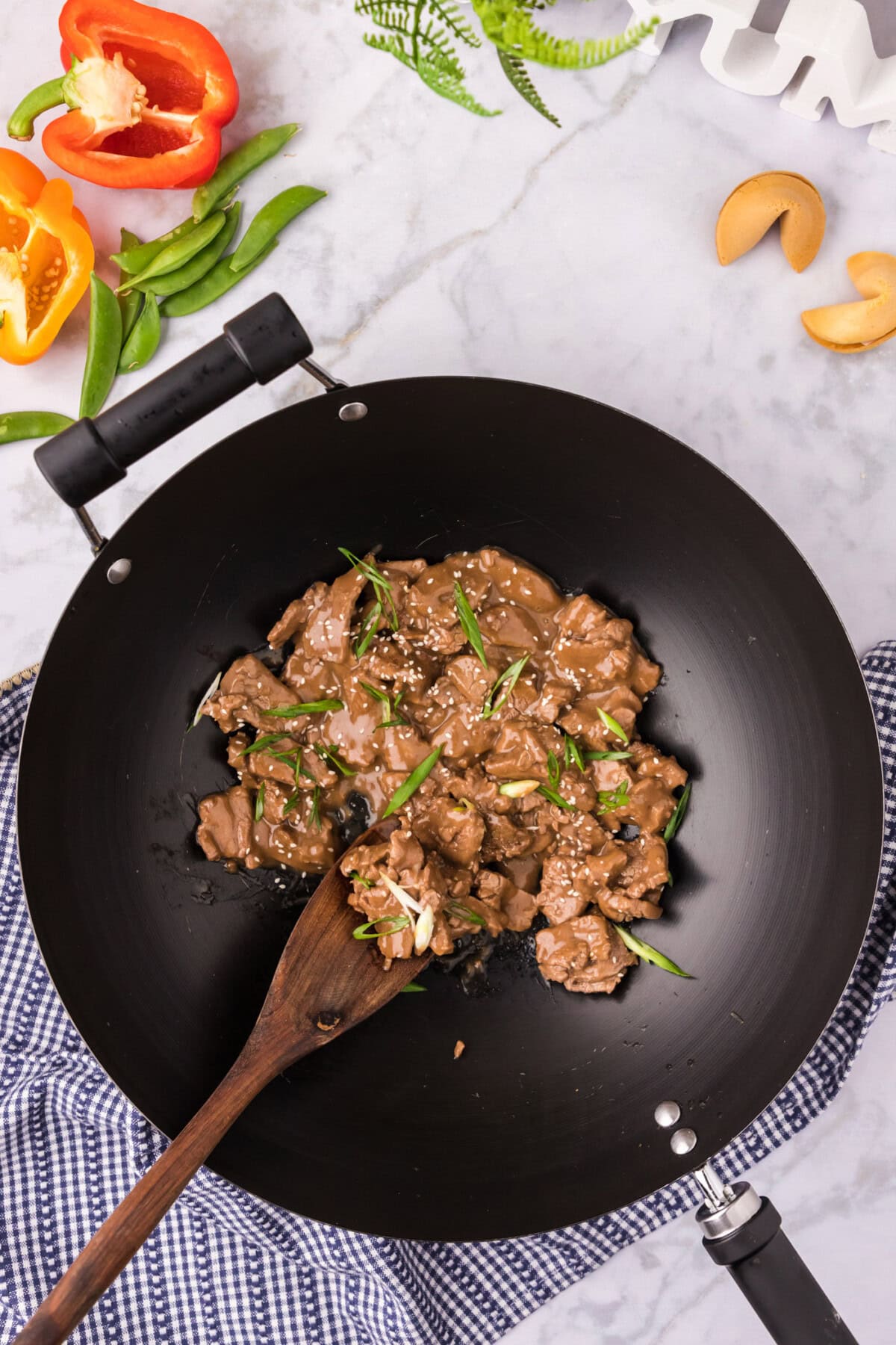 A wok of Beef Teriyaki with a spoon