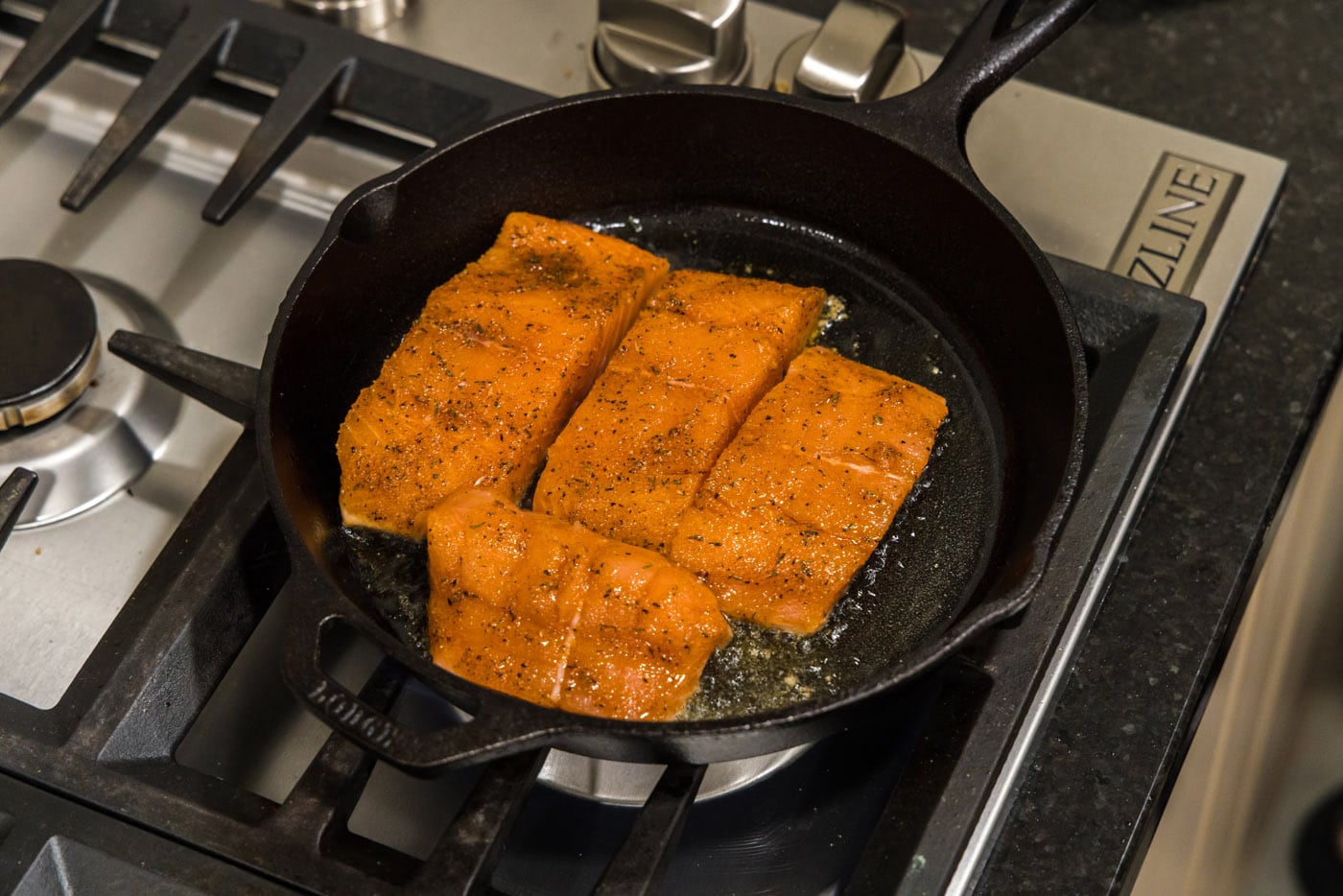 seasoned salmon filets in a skillet