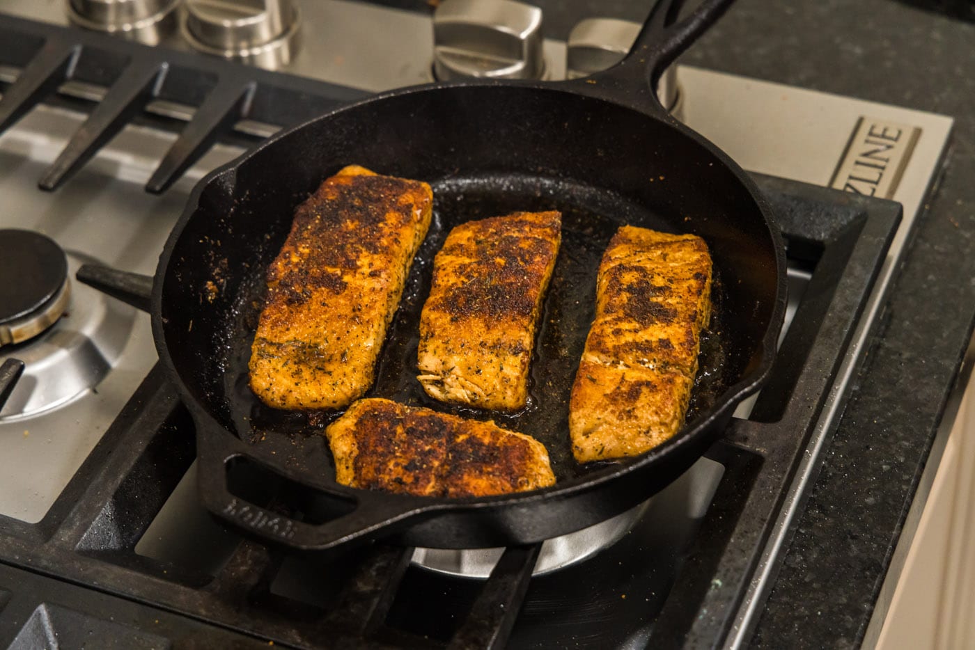 cooked cajun salmon in a skillet