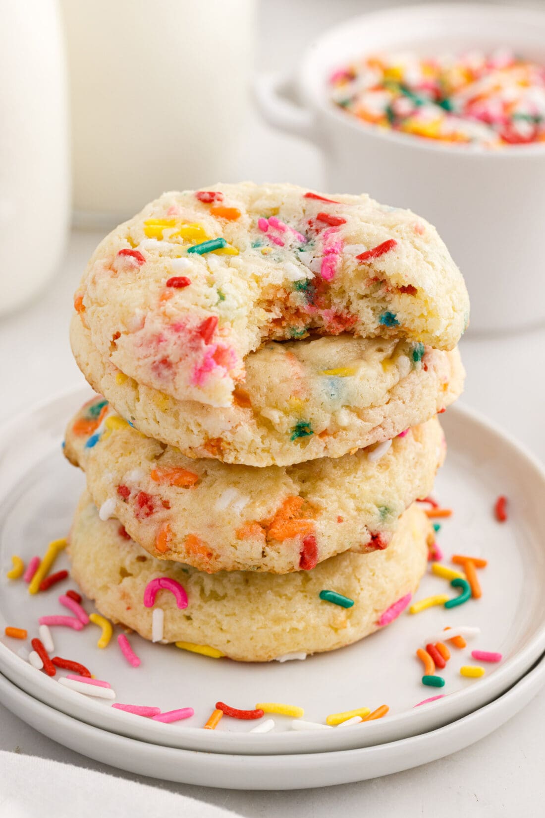 Stack of Funfetti Cake Mix Cookies with a bite taken out of the top one