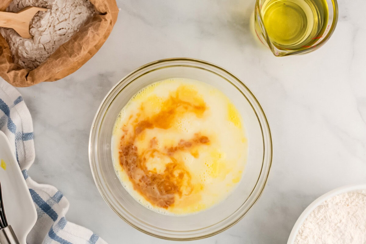 egg, milk, water, and vanilla mixed in a bowl