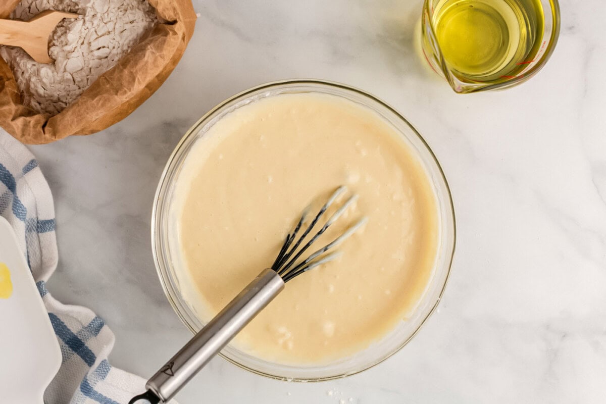 whisked funnel cake batter in a bowl