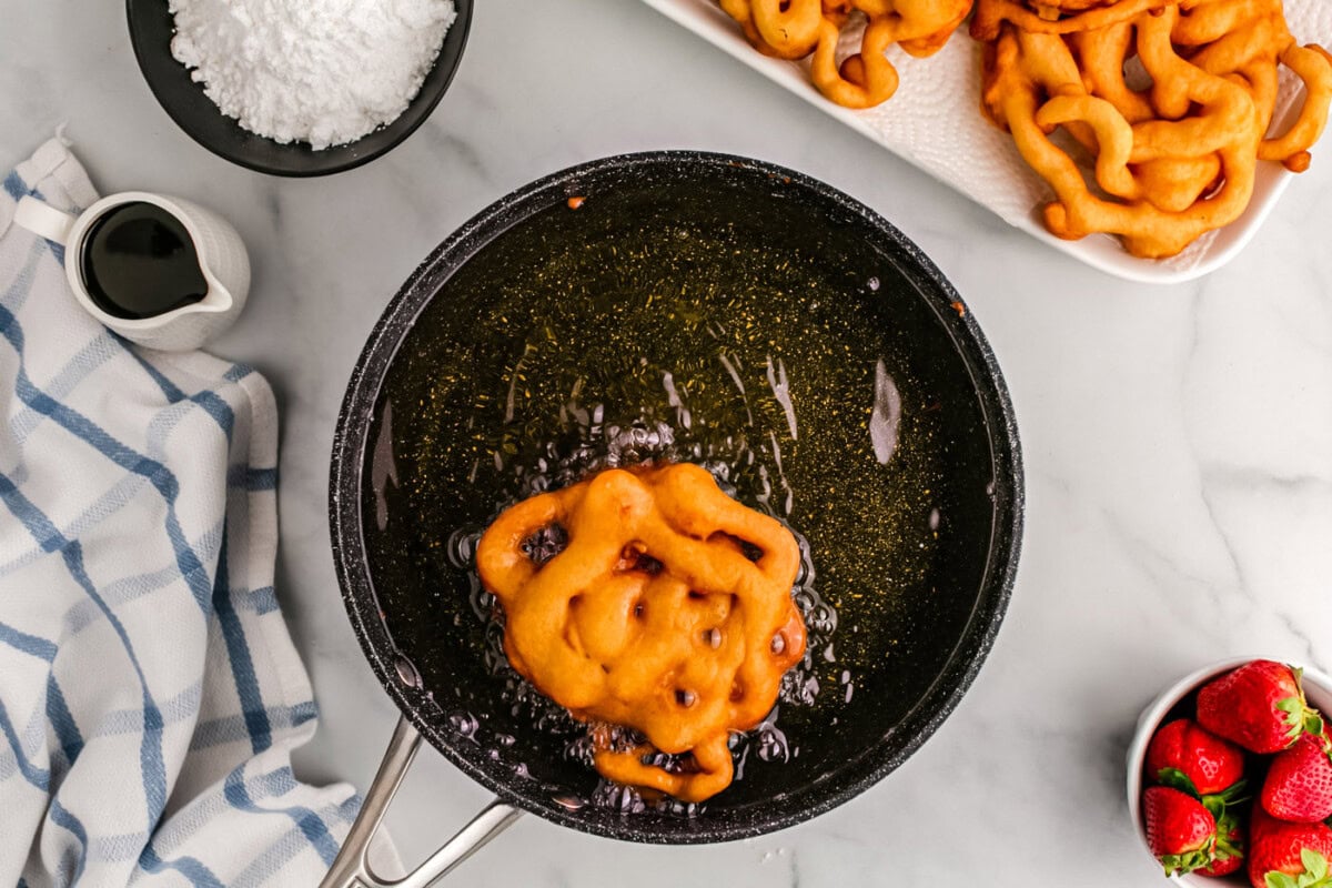 golden fried funnel cake in oil