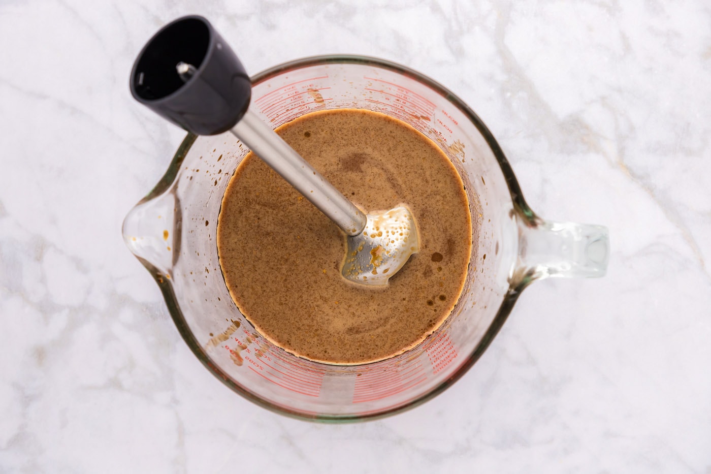 teriyaki sauce ingredients in a cup with an immersion blender